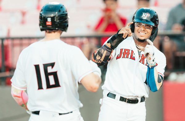 New Jersey Jackals center fielder Todd Isaacs celebrates with teammate Dalton Combs at home plate after Combs delivered a three-run home run during the team's May 21st, 2022 contest against the Gateway Grizzlies. Photo by Phil Hoops